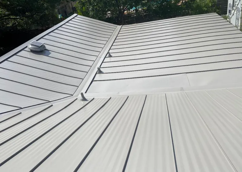 Solar attic fan installed on a metal roof for Roof Ventilation in Berkeley Heights