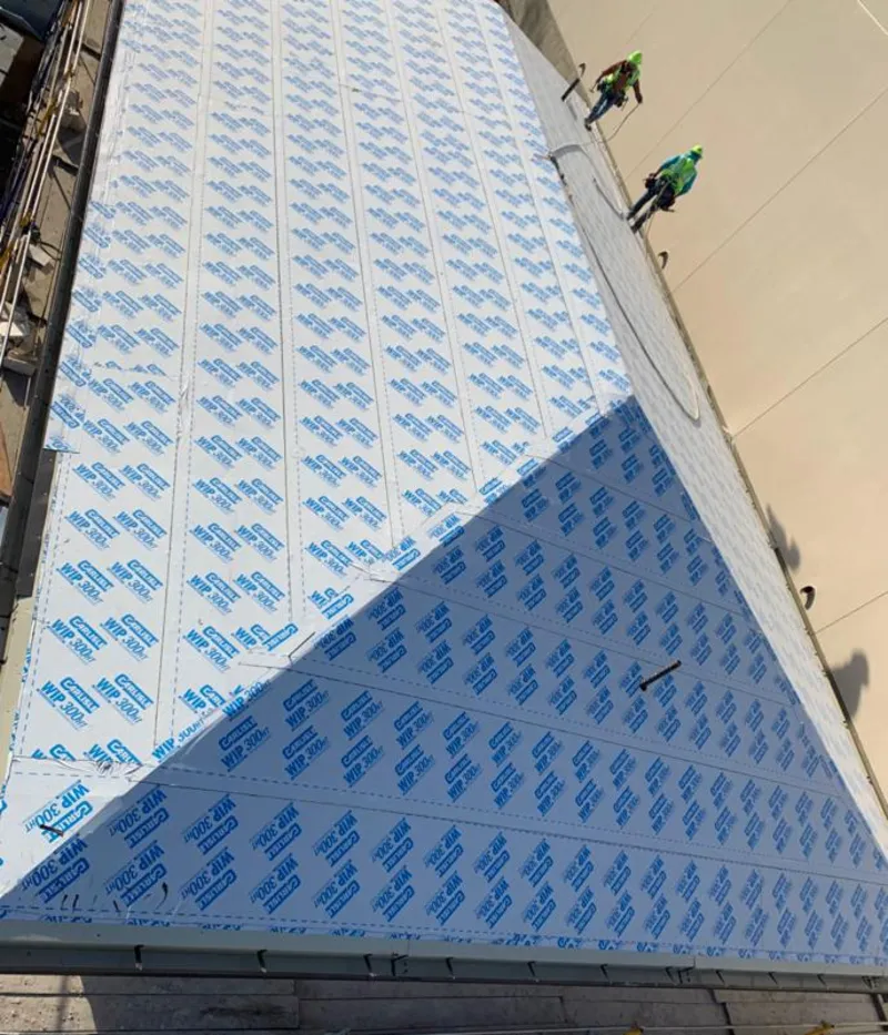 Professional roofers installing underlayment on a metal roof in Berkeley Heights